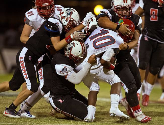 Arbor View's Dekarri Gunn (10) is gang tackled by a host of Liberty defenders during their season opener on Friday, August 26, 2016.