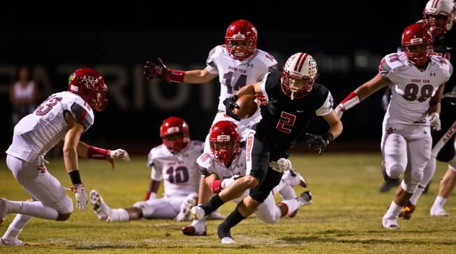 Liberty's Ethan Dedeaux (2) breaks into open field after evading Arbor View defenders during their season opener on Friday, August 26, 2016.