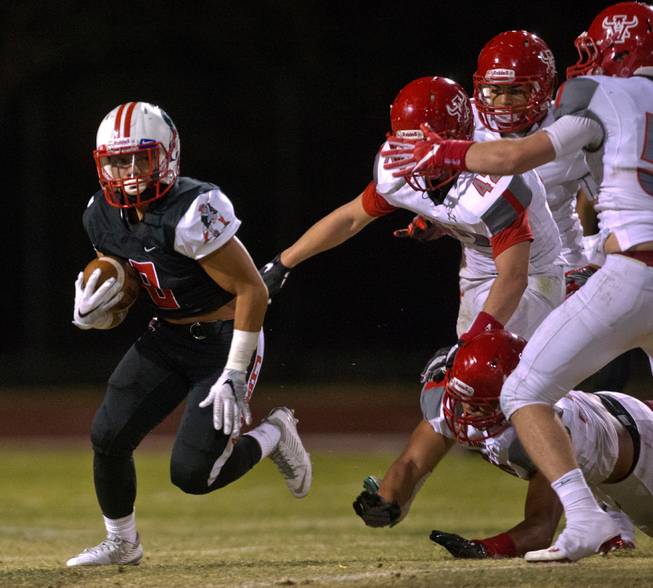 Liberty's Bryson Delacruz (8) turns the corner over Arbor View's defense during their season opener on Friday, August 26, 2016.