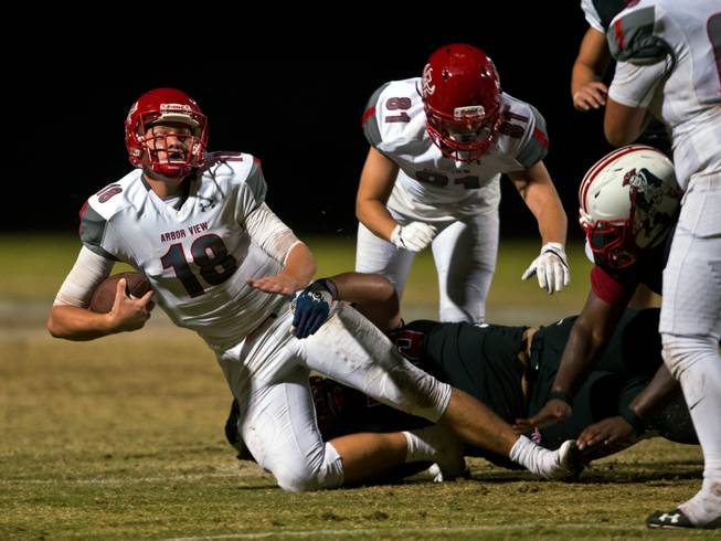 Arbor View QB Hayden Bollinger (18) is sacked ending their late-game drive and giving the win to Liberty during their season opener on Friday, August 26, 2016.