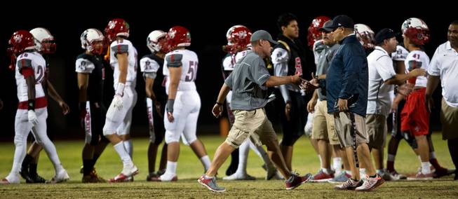 Arbor View head coach Dan Barnson is still angry as he hurriedly shakes the hand of Liberty head coach Richard Muraco following their season opener on Friday, August 26, 2016.