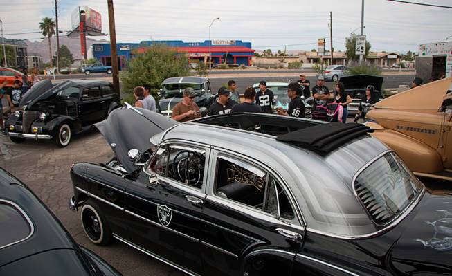 Raiders-themed cars are seen during a pregame event Saturday outside the Las Vegas Raiders Nation Cantina.