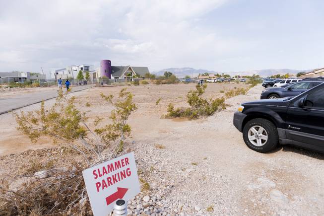 A parking sign guides bargain hunters to a yard sale at Penn Jillette's home, "The Slammer," Saturday, Aug. 27, 2016.