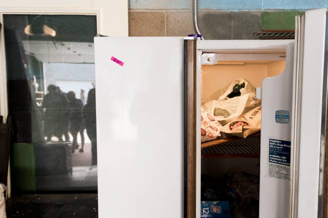 A refrigerator still full of food is for sale during a yard sale at Penn Jillette's home, "The Slammer," Saturday, Aug. 27, 2016.
