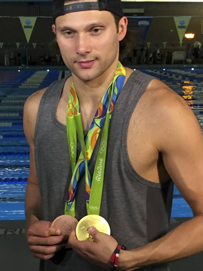 Las Vegas Olympian Cody Miller stands with the gold and bronze medals he won in the 2016 Summer Olympics in Rio de Janeiro during a recognition ceremony at the Desert Breeze Aquatic Facility, Monday, Aug. 29, 2016.