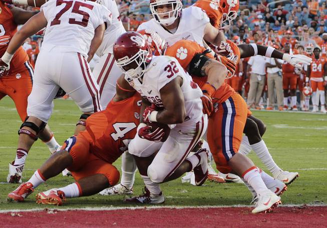 Oklahoma running back Samaje Perine (32) scores a touchdown during the first half of the Orange Bowl NCAA college football semifinal playoff game against  Clemson, Thursday, Dec. 31, 2015, in Miami Gardens, Fla.  