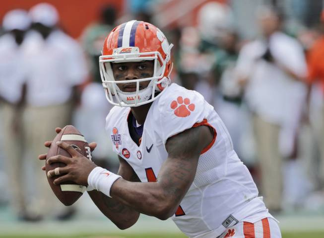 In this Oct. 24, 2015, file photo, Clemson quarterback Deshaun Watson drops back to pass during the first half of an NCAA College football game against Miami, in Miami Gardens, Fla. Watson's hardest choices this fall might be wondering where to go with the football. 