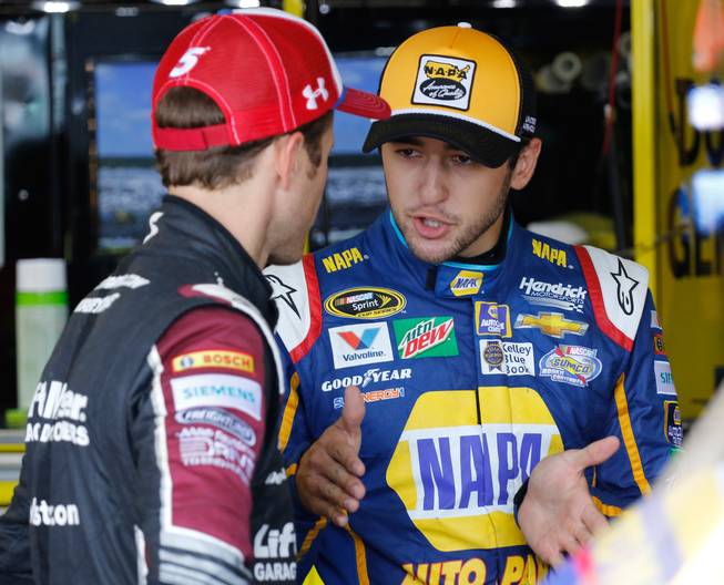 Chase Elliott, right, talks with Kasey Kahne in the garage Saturday, Sept. 3, 2016, during NASCAR Sprint Cup auto racing practice at Darlington Raceway in Darlington, S.C.