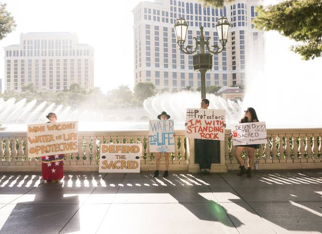 Protestors hold up sign during the "We Stand with Standing Rock" protest in support of the Standing Rock Sioux tribe, in front of the Bellagio Casino, Friday, Sept. 9, 2016. The Standing Rock Sioux tribe is fighting to stop the Dakota Access Pipeline (DAPL) from passing through their lands in North Dakota, which they say will contaminate the water and violate sacred grounds.