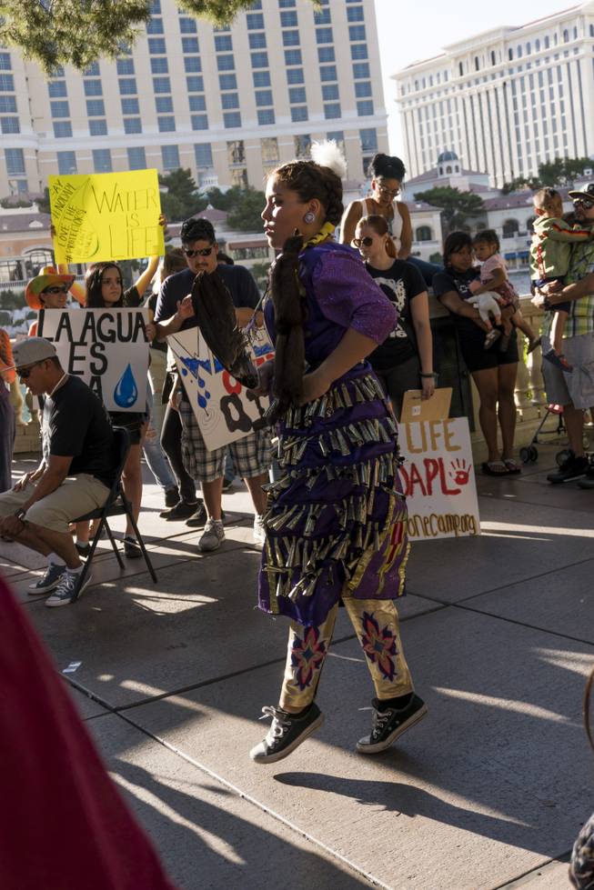 A protestor performs during the "We Stand with Standing Rock" protest in support of the Standing Rock Sioux tribe, in front of the Bellagio Casino, Friday, Sept. 9, 2016. The Standing Rock Sioux tribe is fighting to stop the Dakota Access Pipeline (DAPL) from passing through their lands in North Dakota, which they say will contaminate the water and violate sacred grounds.