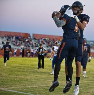 Legacy's Marquell Evans (8) celebrates with teammate Jamaal Britt (1) after a quick touchdown run over Moapa Valley during their high school football game on Friday, Sept. 9, 2016.