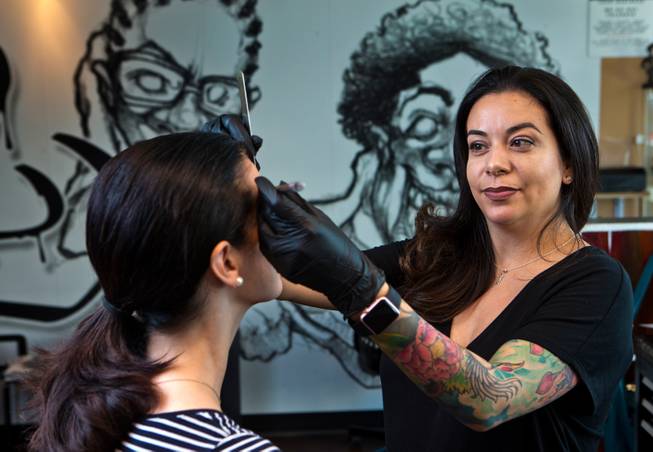 Elly Brown begins the process of semi-permanent eyebrows done by Jenn Glover at Black Spade Tattoo on Tuesday, August 23, 2016. L.E. Baskow.