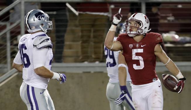 Stanford running back Christian McCaffrey (5) celebrates his 41-yard touchdown run next to Kansas State's Jayd Kirby, left, during the second half of an NCAA college football game Friday, Sept. 2, 2016, in Stanford, Calif. Stanford won 26-13. 