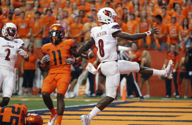 In this Sept. 9, 2016, file photo, Louisville's Lamar Jackson high-steps into the end zone for a touchdown during an NCAA college football game against Syracuse in Syracuse, N.Y. Louisville faces Florida State this week. In two games, Jackson has thrown for six touchdowns, and rushed for six more. 