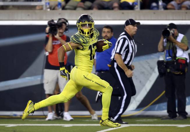 Oregon's Devon Allen is all alone as he sprints to the end zone after pulling down a Dakota Prukop pass against Virginia during the third quarter of an NCAA college football game Saturday, Sept. 10, 2016 in Eugene, Ore. 