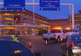 Cars are diverted away from the McCarran International Airport parking garage after a shooting Monday, Sept. 19, 2016. 