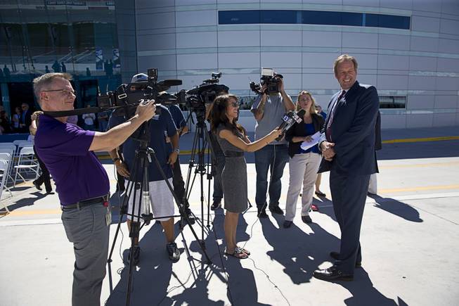 North Las Vegas Mayor John Lee turns as a NASCAR-style race car heads to the garage during a Nevada Department of Transportation (NDOT) news conference at the Las Vegas Motor Speedway Monday, Sept. 19, 2016. NDOT announced the groundbreaking of a $33.8 million widening of I-15 between Craig Road and the Speedway.