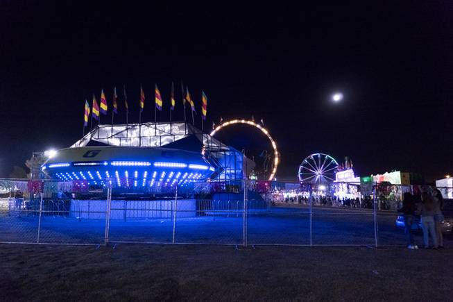 The harvest moon hangs low in the sky during the San Gennaro Feast Festival at Craig Ranch Park in North Las Vegas, Friday, Sept. 16, 2016.