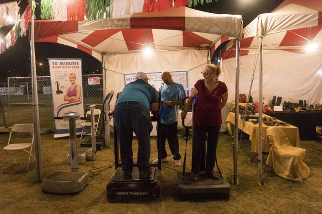 A festival goer test out a libra therapy machine during the 37th Annual San Gennaro Feast Festival at Craig Ranch Park in North Las Vegas, Friday, Sept. 16, 2016.