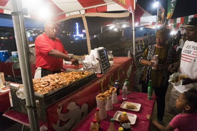 Festival goers stop to get some cajun style shrimp from T&T's during the 37th Annual San Gennaro Feast Festival at Craig Ranch Park in North Las Vegas, Friday, Sept. 16, 2016.