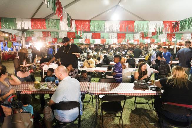The crowd gathers at the dining tables to rest and eat during the 37th Annual San Gennaro Feast Festival at Craig Ranch Park in North Las Vegas, Friday, Sept. 16, 2016.