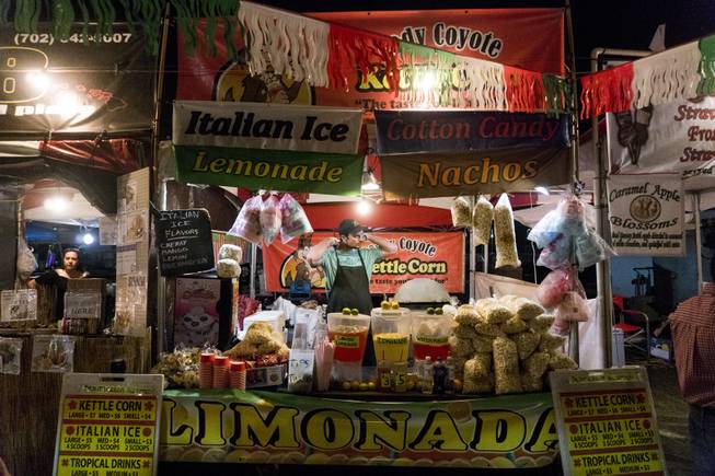 A vendor is buried in products and signs at his booth during the 37th Annual San Gennaro Feast Festival at Craig Ranch Park in North Las Vegas, Friday, Sept. 16, 2016.