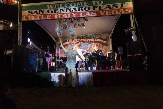 A festival goer performs for the crowd as singer Denis Clemente performs on stage during the 37th Annual San Gennaro Feast Festival at Craig Ranch Park in North Las Vegas, Friday, Sept. 16, 2016.