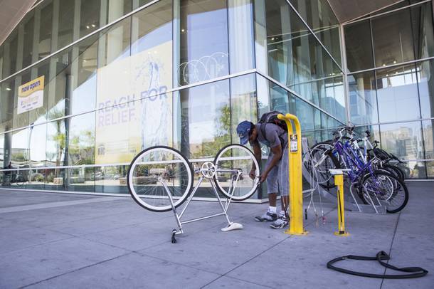Abdul Muhammed fixed a flat on his bike outside of the RTC Bike Center at the Bonneville Transit Center, Monday, Sept. 19, 2016.