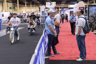 Attendees talk while others take advantage of a demo track to try out different rides during the annual Interbike International Bicycle Exposition, the largest industry show in North America, Wednesday, Sept. 21, 2016 at the Mandalay Bay Convention Center in Las Vegas.