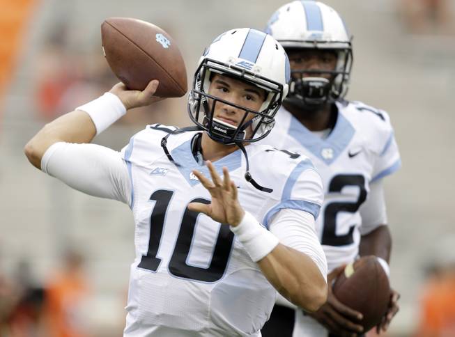  In this Sept. 27, 2014, file photo, North Carolina's Mitch Trubisky (10) warm ups before an NCAA college football game against Clemson in Clemson, S.C. North Carolina coach Larry Fedora, on Friday, April 22, 2016, has named Trubisky as starting quarterback for the opener against Georgia. 