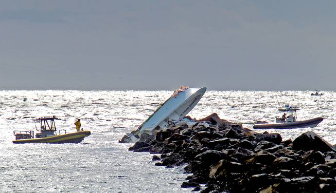 A boat lies overturned on a jetty Sunday, Sept. 25, 2016, off Miami Beach, Fla. Authorities said that Miami Marlins starting pitcher Jose Fernandez was one of three people killed in the boat crash early Sunday morning. Fernandez was 24.