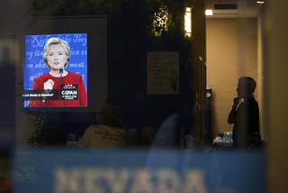 A man listens to Hillary Clinton during a presidential debate viewing party at a Democratic Party field office Monday, Sept. 26, 2016.