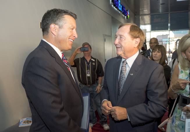 Nevada Gov. Brian Sandoval, left, and Rossi Ralenkotter, president and CEO of the Las Vegas Convention and Visitors Authority, chat at the opening of the MINExpo International mining equipment show at the Las Vegas Convention Center in Las Vegas on Monday, Sept. 26, 2016.