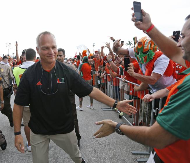 Miami coach Mark Richt high-fives fans as the team arrives at the stadium for an NCAA college football game against Florida A&M in Miami Gardens, Fla. No. 25 Miami could be walking into trouble when it visits Boone, N.C., to face an Appalachian State program in its third year in the Bowl Subdivision. Its by far the biggest game at the FBS level for the Mountaineers, who took No. 15 Tennessee to overtime two weeks ago.