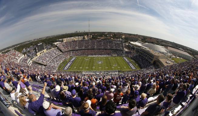 Fans cheer the opening kick- off as the Texas Longhorns take on the TCU Horned Frogs in an NCAA college football game Saturday, Oct. 3, 2015,  at Amon G. Carter Stadium in Fort Worth, Texas. 