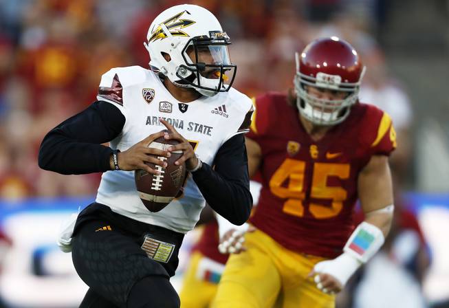 Arizona State quarterback Manny Wilkins (5) runs the football away from Southern California defensive end Porter Gustin (45) during the first half of an NCAA college football game Saturday, Oct. 1, 2016, in Los Angeles.