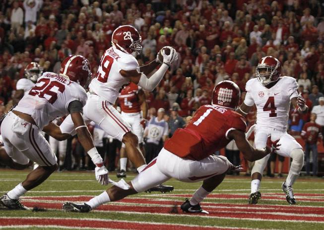 Alabama's Minkah Fitzpatrick (29) intercepts a pass intended for Arkansas' Jared Cornelius (1) in the Arkansas end zone during the fourth quarter of an NCAA college football game Saturday, Oct. 8, 2016, in Fayetteville, Ark. Alabama won 49-30. 