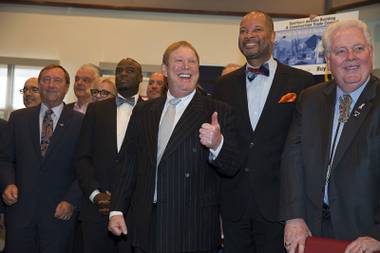 Raiders owner Mark Davis, center, gives a thumbs up during a bill signing ceremony at UNLV Monday, Oct. 17, 2016. Also pictured from left, Rossi Ralenkotter, president and CEO of the Las Vegas Convention and Visitors Authority, State Sen. Kelvin Atkinson, State Sen. Aaron Ford and Speaker of the Assembly John Hambrick.