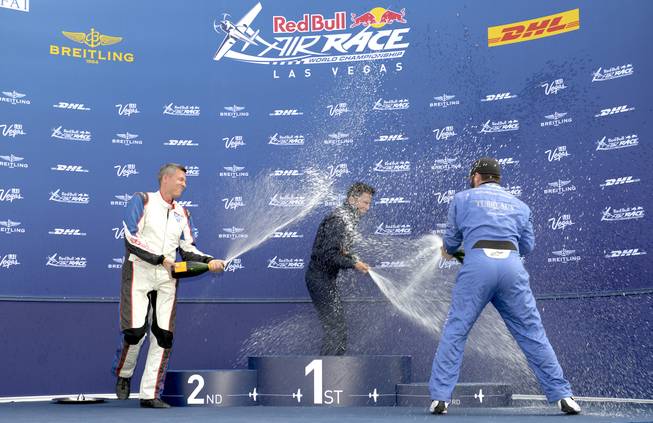 Red Bull Air Race Challenger Cup winners spray each other with champagne during the awards presentation. The final race in the Challenger Cup series was cancelled due to high winds at the Las Vegas Motor Speedway, therefore, the pilots with the highest standings going into taday's competition were given awards.  First place going to Florian Berger of Germany (center), second place going to Daniel Ryfa (left) of Sweden and third place going to Kevin Coleman (right) of the United States. Sunday,October 16, 2016.