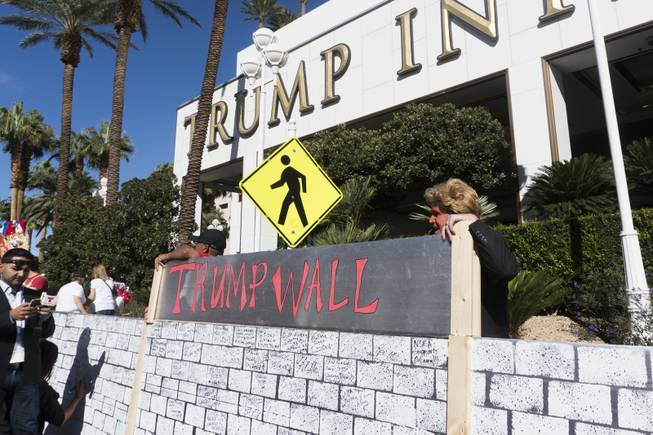 Protestors were encouraged to sign a makeshift "Trump Wall" during a "Taco-Truck-Wall" Culinary Union Local 226 protest at Trump International, Wednesday, Oct. 19, 2016.