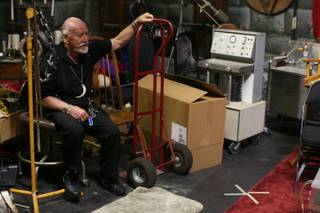 In this file photo, movie-maker of more than 50 years, Ted V. Mikels, sits amid the props from some of his films at his Las Vegas office and studio on Monday, Oct. 6, 2008. 