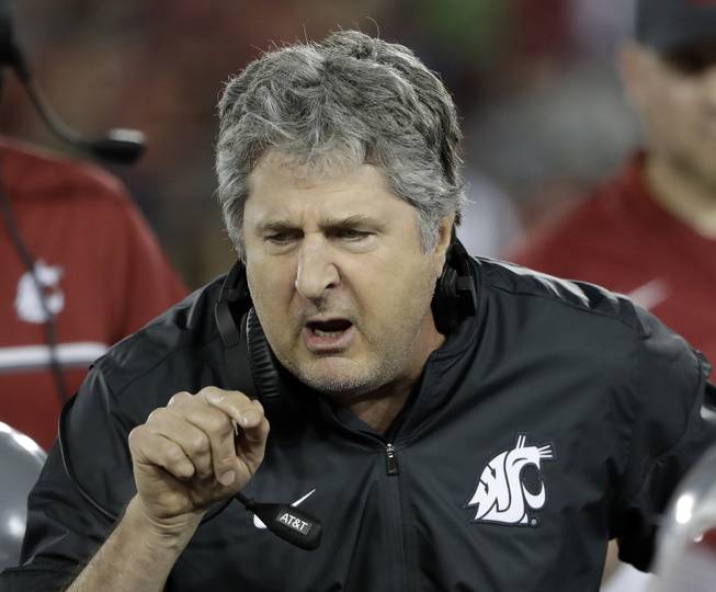  In this Oct. 8, 2016, file photo, Washington State head coach Mike Leach instructs his team during the second half of an NCAA college football game against Stanford, in Stanford, Calif. Washington State's four-game win streak and return to contention in the Pac-12 can be attributed to the Cougars determination to run the ball on offense. History shows that when Mike Leach's teams are having their most success, running the ball is a huge reason why.