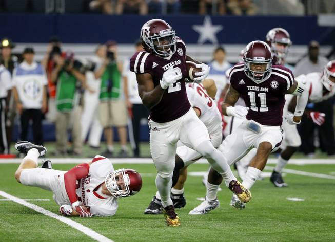 Arkansas defensive back Ryder Lucas (24) is unable to stop Texas A&M wide receiver Speedy Noil (2) as Noil returns a kick off in the first half of an NCAA college football game, Saturday, Sept. 24, 2016, in Arlington, Texas. 
