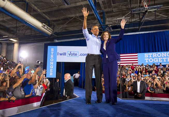 President Barack Obama waves with Nevada Senate candidate Catherine Cortez Masto as he campaigns for her and Democratic presidential nominee Hillary Clinton at Cheyenne High School in North Las Vegas Sunday, Oct. 23, 2016.