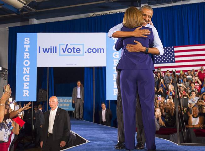 President Barack Obama gives a hug to Nevada Senate candidate Catherine Cortez Masto during a rally at Cheyenne High School in North Las Vegas Sunday, Oct. 23, 2016.