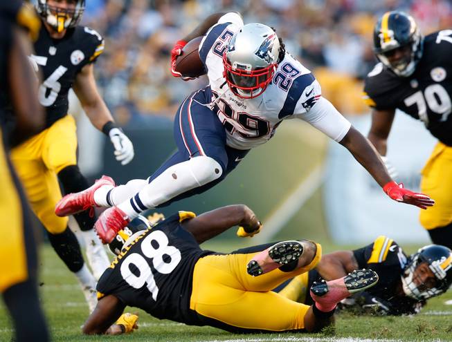 New England Patriots running back LeGarrette Blount (29) is upended by Pittsburgh Steelers inside linebacker Vince Williams (98) during the first half of an NFL football game in Pittsburgh, Sunday, Oct. 23, 2016. (AP Photo/Jared Wickerham)