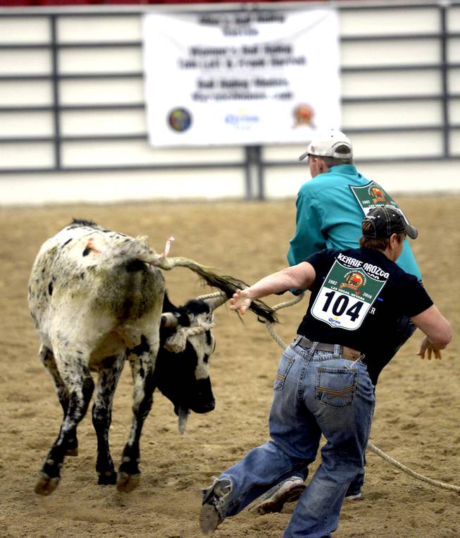 Teeny Copafeelya, of Elizabeth, CO attaches the pink ribbon to the steers tail and makes a run for it while team mate Kevin Euser of Denver, CO tries to detach the rope it's horns in the Steer Decorating event during the International World Gay Rodeo Finals at South Point Hotel/Casino in Las Vegas. Saturday, October 22, 2016. International World Gay Rodeo Finals at South Point Hotel/Casino in Las Vegas. Saturday, October 22, 2016.