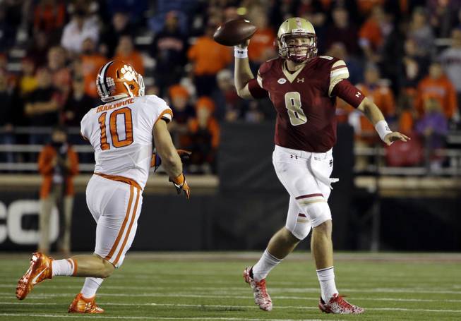 Boston College quarterback Patrick Towles (8) throws under pressure from Clemson linebacker Ben Boulware (10) during the first half of an NCAA football game Friday, Oct. 7, 2016, in Boston. 