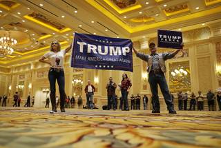 Sherry, left, and Tony Parsons hold up a sign before a rally with Republican presidential candidate Donald Trump, Sunday, Oct. 30, 2016, in Las Vegas.