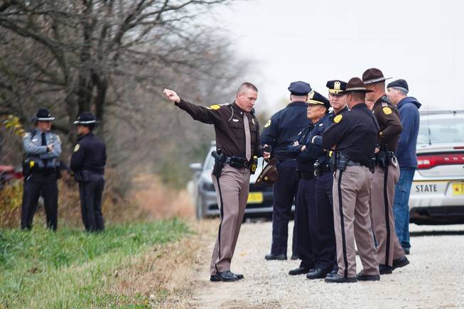 Detectives investigate the scene outside of Redfield, Iowa, Wednesday, Nov. 2, 2016,  where 46-year-old Scott Michael Greene was taken into custody for the fatal shooting of two Des Moines area police officers. (Brian Powers/The Des Moines Register via AP)